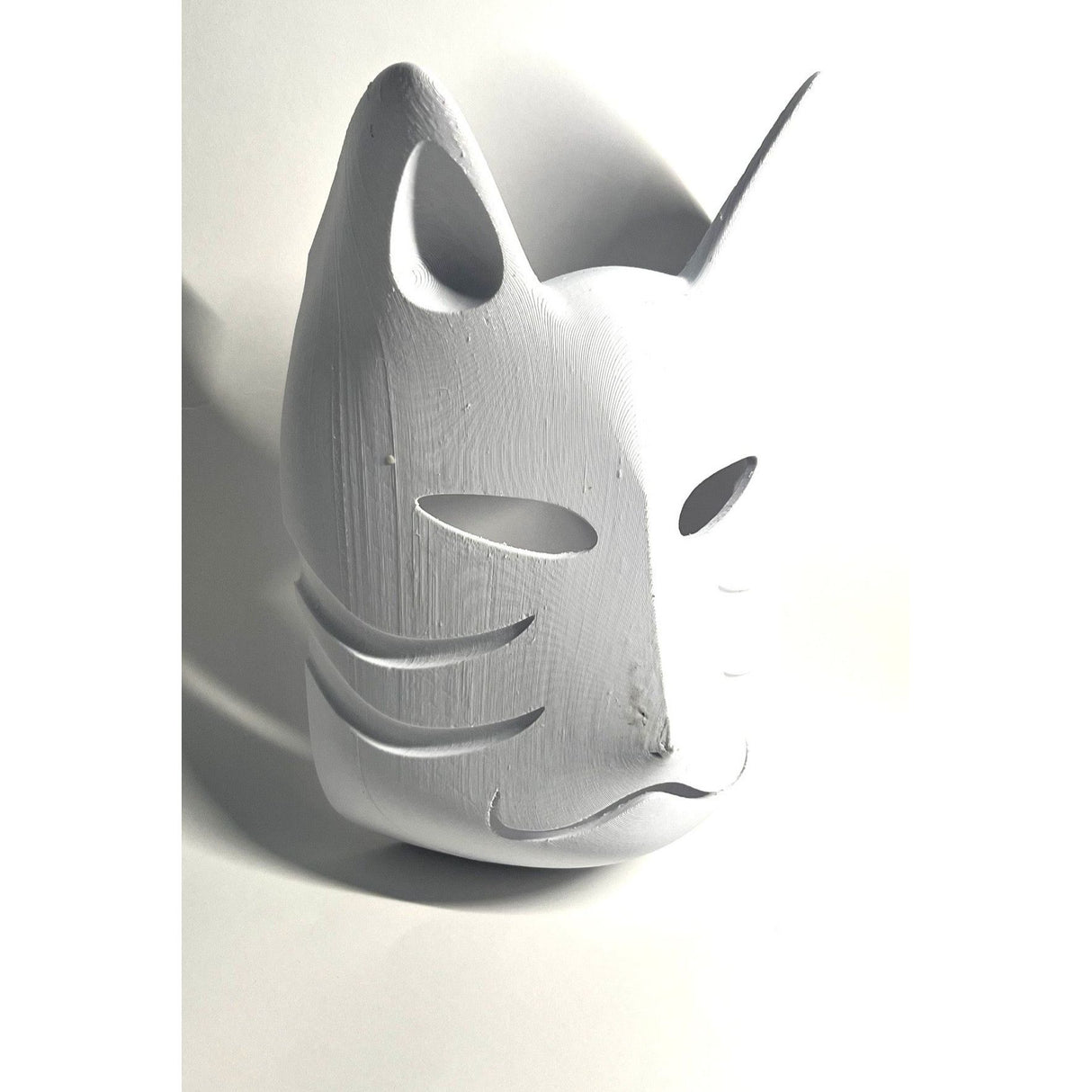 Blank canvas DIY Anbu mask by Kawaii King, ready for customization, featuring a smooth surface and mask shape.