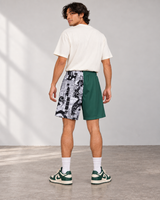 Power of Youth Boardshorts, back view on model with ivory tee and green sneakers.