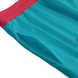 Teal Slayer Masks boardshort by Yoycol featuring an XS drip design, displayed with waistband and floral accents.